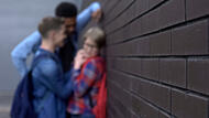 Students bullying classmate in school backyard, children rights