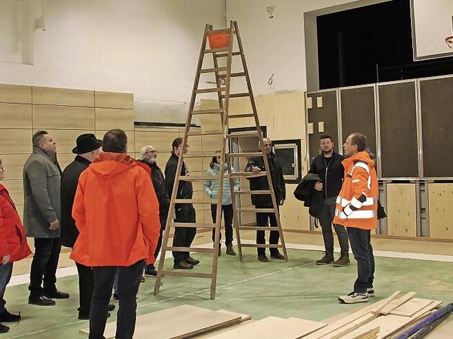 Bautechniker Frank S&ouml;llner informierte die Mitglieder des Bauausschusses bei einem Ortstermin &uuml;ber die Sanierungsarbeiten in der Grundschulturnhalle, die Mitte Januar 2026 abgeschlossen sein werden.