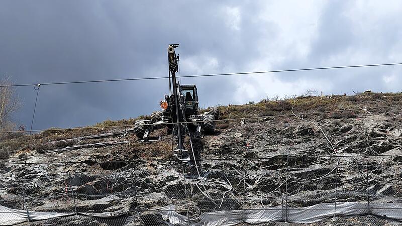 Mit einem Schreitbagger wird loses Ger&ouml;ll gesichert.