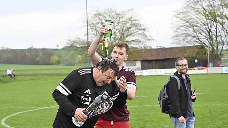 Adrian Brehm verpasst seinem Trainer Mario Lochmann nach der Kreisliga-Meisterschaft eine Sektdusche.