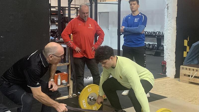 Der ehemalige Gewichtheber Martin Zawieja gibt Hammerwerfer Merlin Hummel Tipps f&uuml;r das Krafttraining. Im Hintergrund Martin St&auml;ndner und Linus Liebenwald (von links).