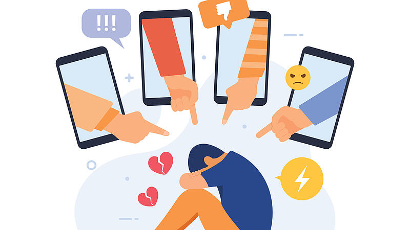 Cyber bullying in social networks and online abuse concept. Young man crying in front of laptop screen due to haters messages Cybermobbing