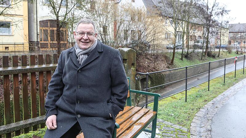 Hans-Jürgen Scheerbaum steht am Lieblingsplatz in Rattelsdorf, neben  seinem Haus mit Blick auf den historischen Ortskern.