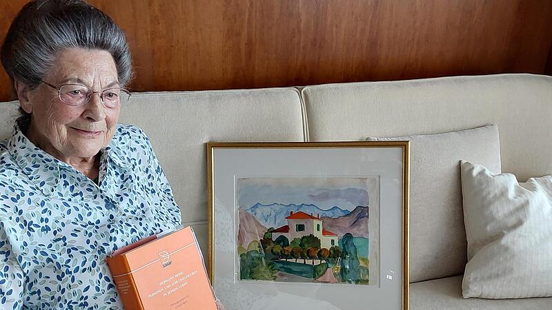 Ursula Apel mit einem ihrer Nachschlagewerke und dem von Hermann Hesse gemalten Bild