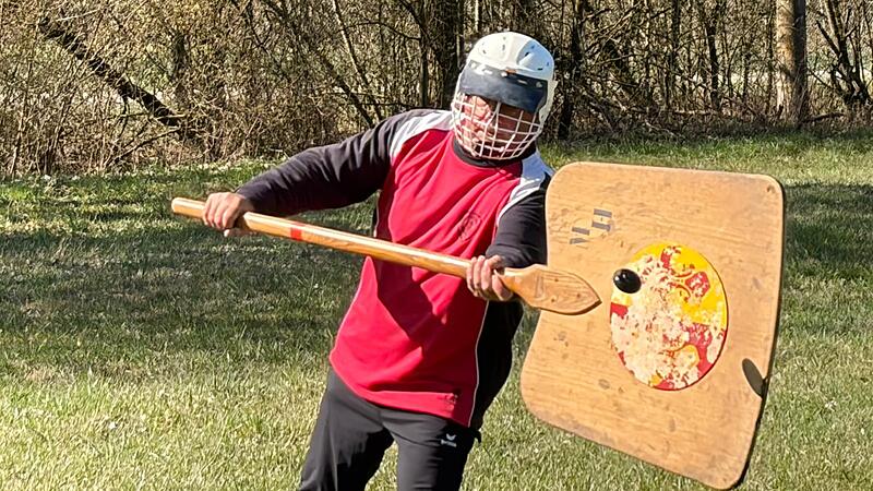 Gut zu erkennen: der schwarze Hornuss wird vom Spieler mit der Schindel "abgetan", bevor er auf den Boden f&auml;llt - Punkt f&uuml;r die Schindelmannschaft.