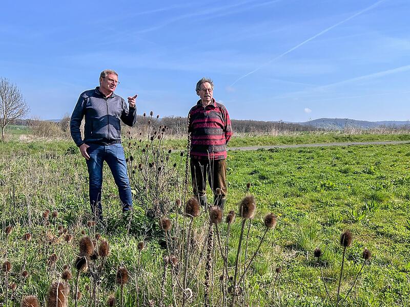 Biologe Dietmar Will (links) auf Standortbewertung: Links der Bl&uuml;hstreifen, rechts der bewirtschaftete Acker. Begleitet wird er von J&auml;ger Toni Schenk.
