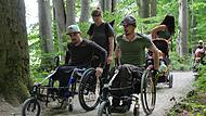 Mit einem von Dominik Herrmann (rechts) entwickelten luftbereiften Vorsatzrad ist es möglich, einen Rollstuhl als Dreirad zu benutzen und somit auf unebenen Pisten zu fahren.Forchheim & Fränkische Schweiz Mit einem von Dominik Herrmann (rechts) entwickelten luftbereiften Vorsatzrad ist es möglich, einen Rollstuhl als Dreirad zu benutzen und somit auf unebenen Pisten zu fahren.Forchheim & Fränkische Schweiz