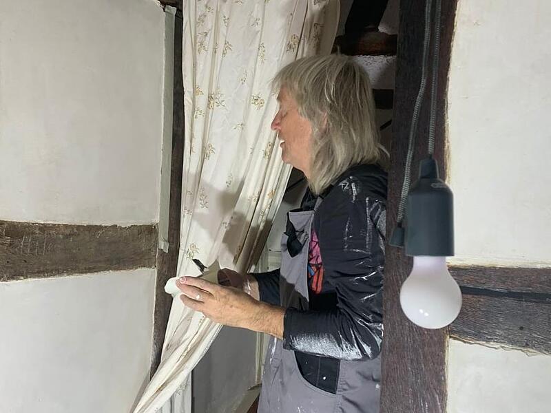 Erich Wendler, ein Helfer aus Franken, streicht bei Familie Jakobs eine Wand.