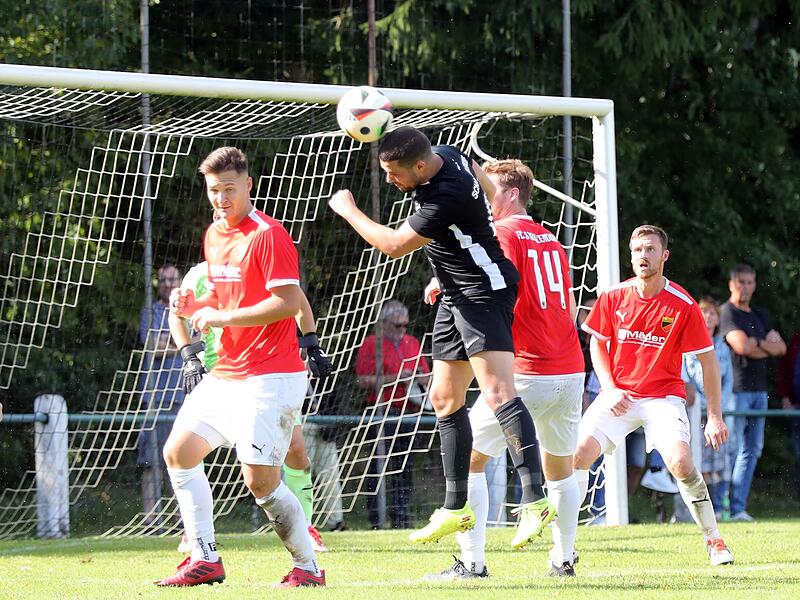 Per Kopf erzielt der Schammelsdorfer Pascal Herbst den 2:2-Ausgleich. Die beiden Strullendorfer Michael Pfänder (links)  und  Niklas Griebel (rechts)  haben das Nachsehen.