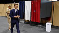 Emmanuel Macron, Präsident von Frankreich, und seine Frau Brigitte verlassen in Paris die Wahlkabine, bevor sie ihre Stimmen in der ersten Runde der französischen Parlamentswahl abgeben.