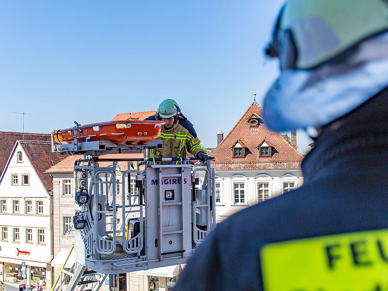 Die Schleifkorbtrage wird mit der Drehleiter nach oben gefahren.