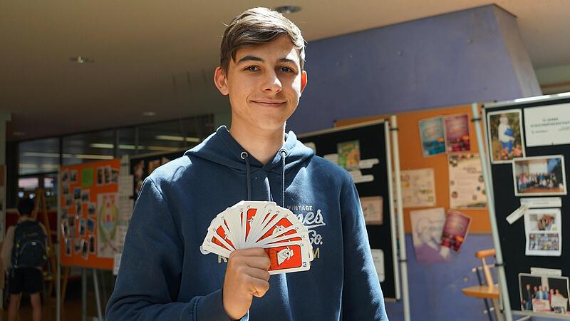 Schüler Marvin Heienbrock des Gymnasiums Höchstadt zeigt das Schafkopf Kartendeck.