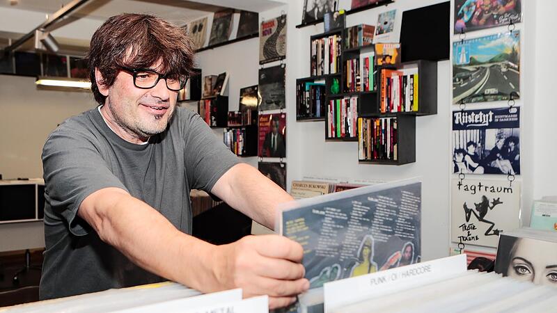 Frank Apunkt Schneider    in  seinem Plattengeschäft   „Monochrom Records“  durch die Auslage.