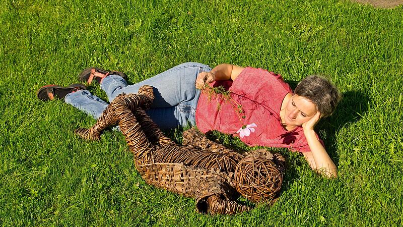 Irmgard Wissing liegt mit ihrem &bdquo;Wolkengucker&ldquo; im Gras.