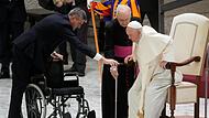 Papst Franziskus steht während der Generalaudienz im Vatikan auf, um zu seinem Rollstuhl zu gehen.