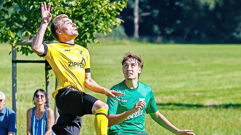 Der Ködnitzer Tim Ittner (links) springt bei diesem Kopfballversuch hoch. Tim Herrmann vom TSV Donndorf-Eckersdorf schaut staunend zu.