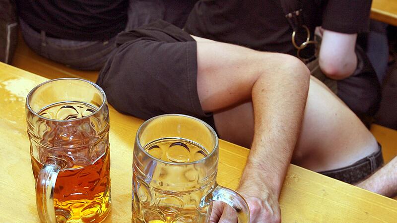 Ein Betrunkener sitzt zusammengesunken in einem Bierzelt Ein Betrunkener sitzt zusammengesunken in einem Bierzelt