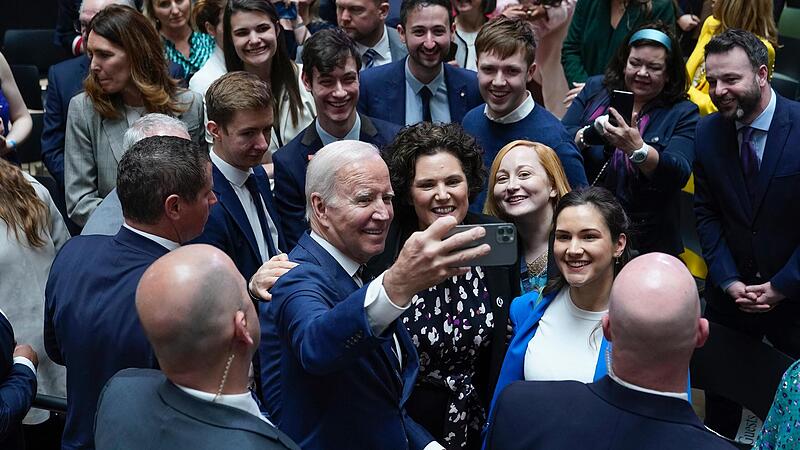 Auf Besuch in Nordirland: Joe Biden, Pr&auml;sident der USA, macht ein Foto mit G&auml;sten nach seiner Rede an der Ulster University in Belfast.
