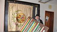 Alois Tremer mit der Fahne des katholischen Burschenvereins Sulzthal in der von ihm gefertigten Vitrine aus dunkler Mooreiche.