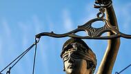Eine Statue der Justitia hält eine Waage in der Hand: Die Straßenverkehrsgefährdung eines 19-jährigen Unfallfahrers war ein Grenzfall und so kommt er noch einmal mit einem blauen Auge davon.