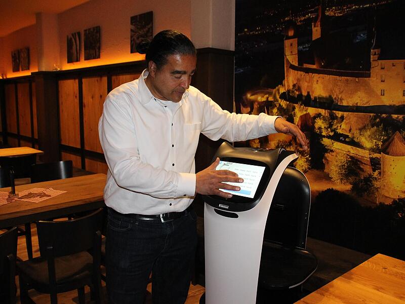 In dieser Woche frisch eingetroffen: Auch im Brauhaus Stadl in Coburg ist jetzt ein Service-Roboter im Einsatz. Hier tippt Wirt Markus Timm auf dem Display ein, wo der flinke Kerl als nächstes hinrollen soll. In dieser Woche frisch eingetroffen: Auch im Brauhaus Stadl in Coburg ist jetzt ein Service-Roboter im Einsatz. Hier tippt Wirt Markus Timm auf dem Display ein, wo der flinke Kerl als nächstes hinrollen soll.