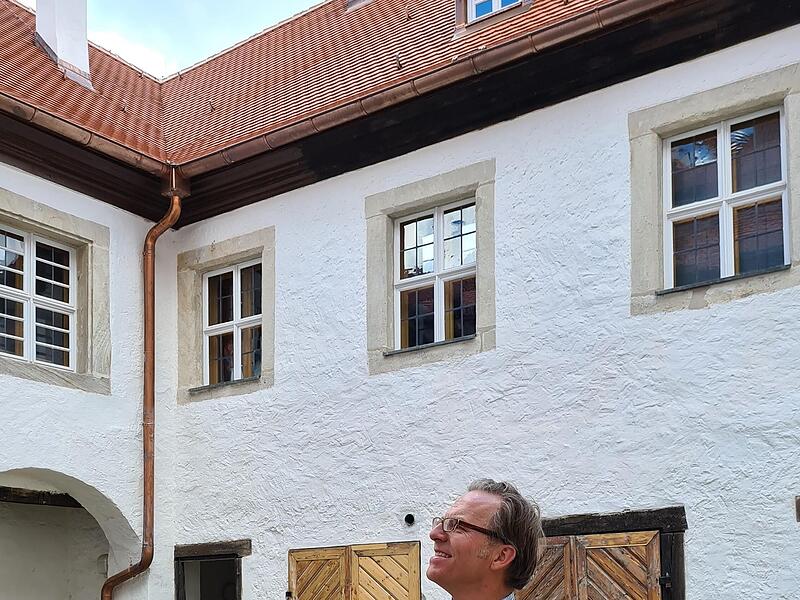 Heinrich von P&ouml;lnitz mit seinem Hund im Innenhof.Forchheim & Fr&auml;nkische Schweiz