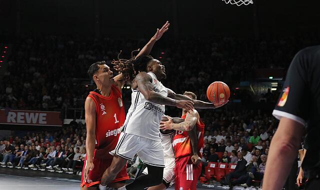 Cobe Williams (in weiß) war zwar Bamberger Topscorer beim Spiel in München, aber hatte einen schweren Stand in Korbnähe.
