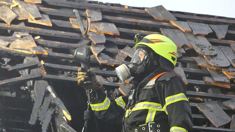 Ein Feuerwehrmann der Feuerwehr R&ouml;dental im Einsatz. Er tr&auml;gt eine Atemschutzmaske.