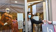 Heike Ammon übergibt eine Überraschungstüte an eine Kundin. Überraschungstüten sind ihr Mittel der Wahl, um die Winterware noch los zu bekommen.Forchheim & Fränkische Schweiz