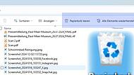 Der Screenshot zeigt das Symbol für den Papierkorb unter Windows sowie, blau hinterlegt, die wichtigsten Papierkorb-Funktionen „Papierkorb leeren“ und „Elemente wiederherstellen“.