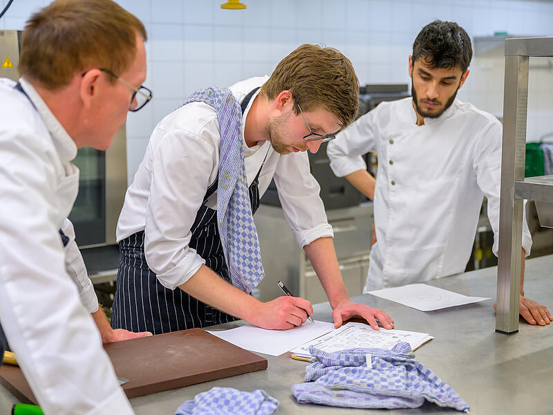 Der Gesch&auml;ftsf&uuml;hrer von Naupaka Poke Benedikt D&ouml;ring mit zwei seiner Mitarbeiter.