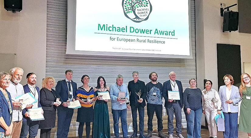 Projektmanagerin Kerstin Brückner (Sechste v. l.) und Gründungsvorsitzender Wolfgang Borst (Fünfter v. r.) zusammen mit weiteren Finalisten und Mitgliedern der Jury des Michael-Dower-Awards 2025.