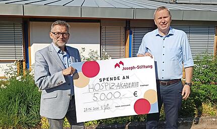 Markus Jakob, Vorstand der Joseph-Stiftung (rechts), &uuml;bergibt symbolisch einen Scheck &uuml;ber 5000 Euro an Markus Starklauf, Leiter der Hospiz-Akademie Bamberg.