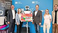 Stephan Kirchner (links) und Frank Seuling (Dritter von rechts) mit seinem Mint-Team und dem humanoiden Roboter &bdquo;pib&ldquo; bei der symbolischen Scheck&uuml;bergabe.