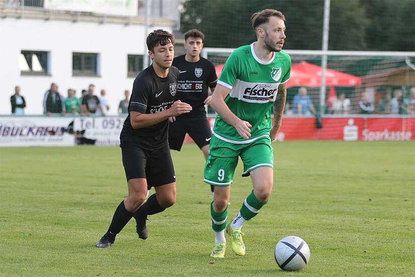 St&uuml;rmer Max Sch&uuml;lein vom SV Friesen (gr&uuml;n) ist  hier in einem Derby gegen seinen Noch-Konkurrenten TSV Neukenroth zu sehen. Nach der laufenden Saison wechselt er  an die Neukenrother Ochsenwiese.