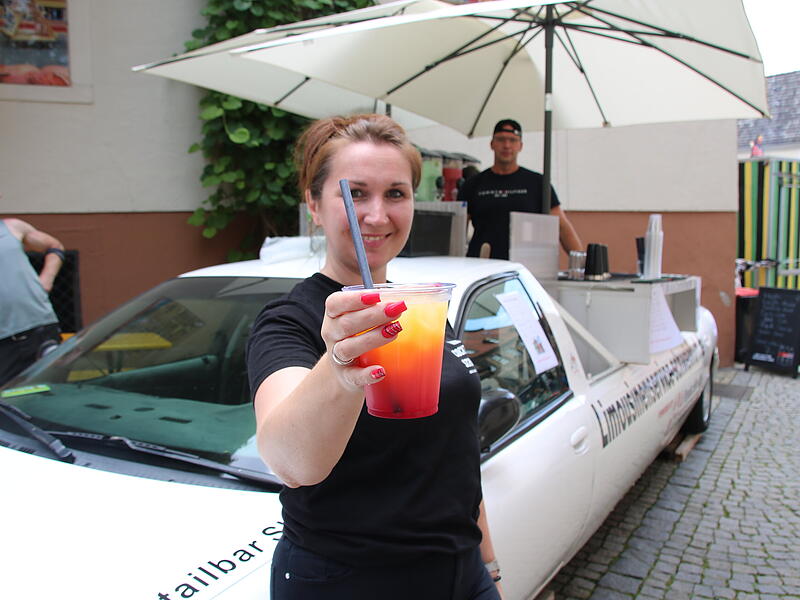 Diana Glück präsentiert einen Cocktail ihrer mobilen Bar beim Streetfoodfestival 2024 in Bad Kissingen