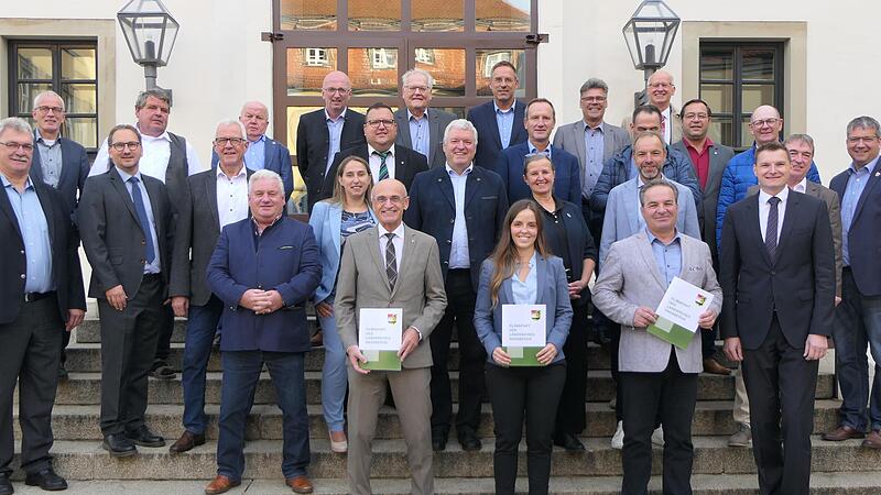 Über die Unterzeichnung des Klimapaktes freuen sich die Bürgermeister zusammen mit (vorne von links) Landrat Wilhelm Schneider, Klimamanagerin Lisa Kötting, Aidhausens Bürgermeister Dieter Möhring als Kreisvorsitzender des Bayerischen Gemeindetage...