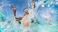 Happy boy playing and splashing in swimming pool Happy boy playing and splashing in swimming pool