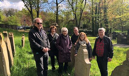 Bruce Mainzer (links) und seine Geschwister am Grab ihrer Urururgro&szlig;vaters Salomon Mainzer (1782 - 1857)