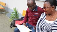 Martins und Bolanle Lawani blicken in ihren Arbeitsvertrag. Sie sitzen vor dem Altenheim in Herzogenaurach, in dem sie tätig waren. Martins und Bolanle Lawani blicken in ihren Arbeitsvertrag. Sie sitzen vor dem Altenheim in Herzogenaurach, in dem sie tätig waren.
