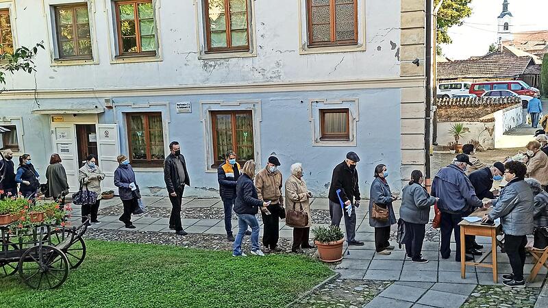 Bed&uuml;rftige stehen bei der Austeilung der vorher gepackten Lebensmittelpakete an.