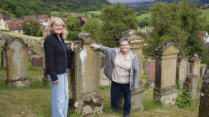 Kreisheimatpflegerin Cornelia Mence und Kulturleiterin Elli B&ouml;ck versuchen, einen der Grabsteine auf dem j&uuml;dischen Friedhof in Pfaffenhausen zu lesen.