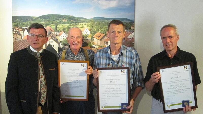 B&uuml;rgermeister Armin Warmuth (links) verlieh Konrad Albert, Horst Manninger und Walter Graf (weiter von links) die Stadtplakette nebst Urkunde f&uuml;r deren kulturelle Verdienste um die Mundart-Musik.