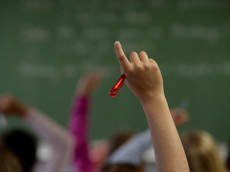 Eine Schülerin meldet sich in einem Klassenzimmer während des Unterrichts. Eine Schülerin meldet sich in einem Klassenzimmer während des Unterrichts.
