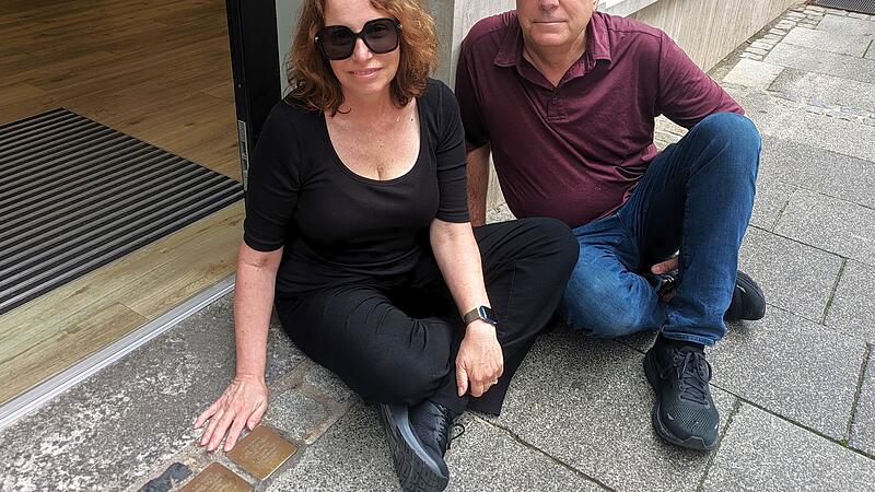 Debbie Peacock, geborene Lowe, mit Ehemann Gavin, sitzen neben dem Stolperstein von Urgroßtante Else Löwinsky Debbie Peacock, geborene Lowe, mit Ehemann Gavin, sitzen neben dem Stolperstein von Urgroßtante Else Löwinsky