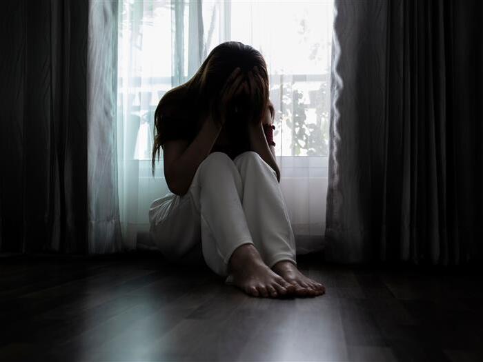 Sad young woman sitting in the bedroom, People with depression concept