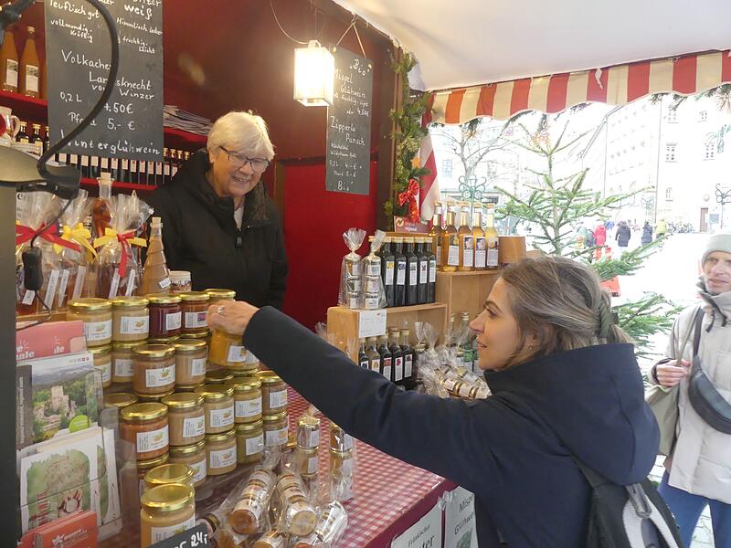 Irmgard Krammer aus Gro&szlig;enseebach in ihrer Bude mit interessierten Kunden aus Malta.