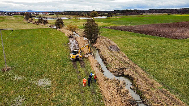 Ein Baggerfahrer gräbt neue Bachschleifen in die Seebach bei Großenseebach.