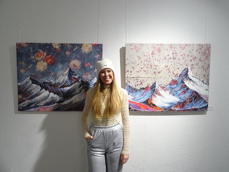 Ausstellungseröffnung Kunstgalerie Marion Kotyba Carina Scherbel vor ihren Werken.