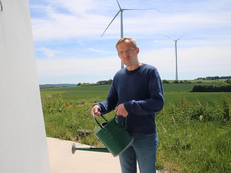 M&uuml;nnerstadts Klimamanager Stefan Richter gie&szlig;t symbolisch  ein Windrad. Er stellte jetzt den Sachstand der von ihm initiierten Projekte vor.